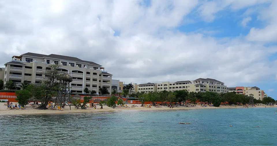 Beachfront pool and palm trees at Iberostar Rose Hall Beach near Montego Bay, Jamaica