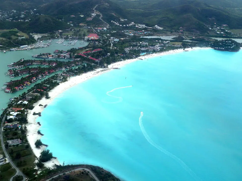 Aerial-style view of Jolly Beach Resort buildings, Jolly Harbour marina and nearby villas in Antigua